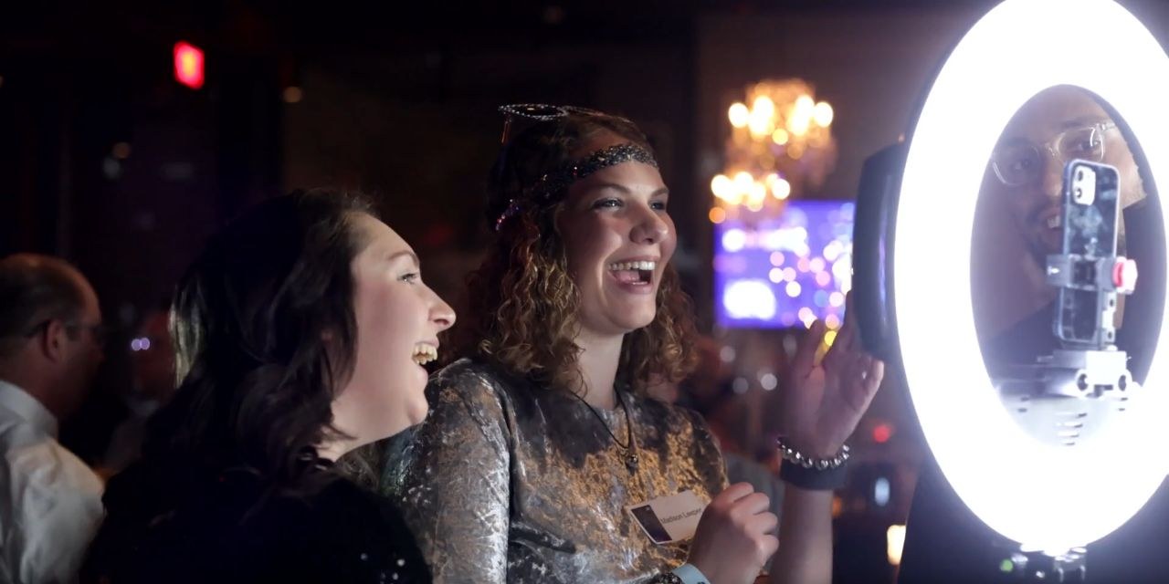 Two DaVita guests laughing together in front of the Viewso capture setup