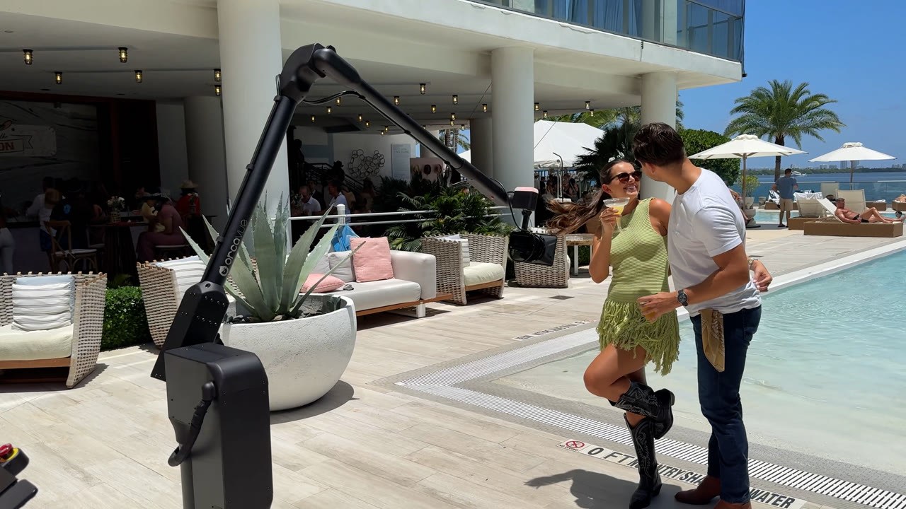 A couple posing for a poolside Glambot capture